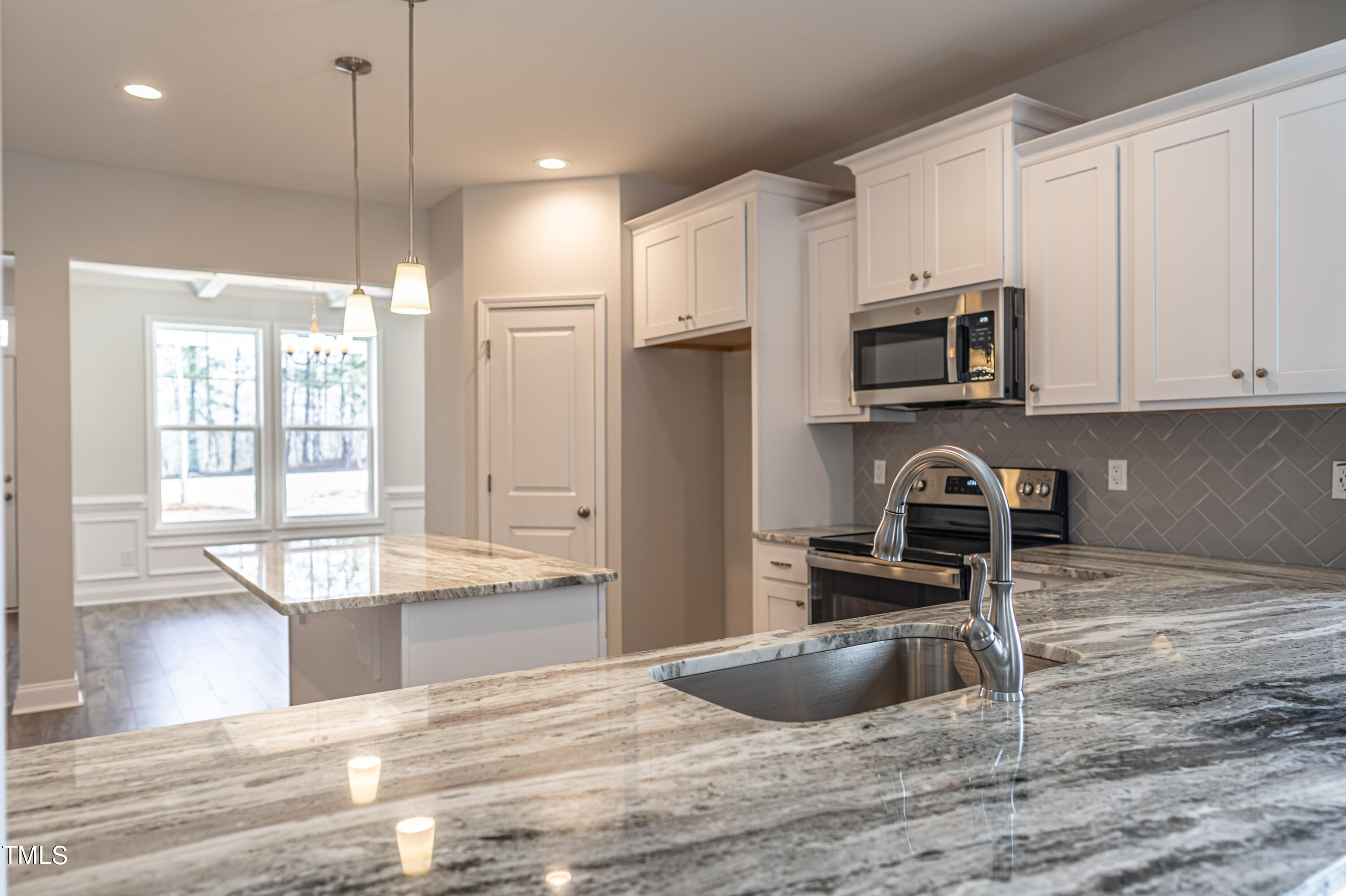 4298 Carthage Road West End, NC 27376 - Photo 10 of 22 a kitchen with kitchen island granite countertop a sink stainless steel appliances and cabinets