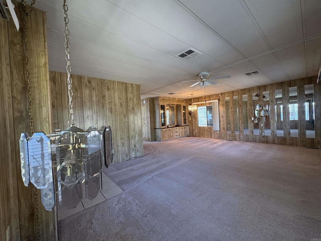 7467 Mission Gorge Road, Unit 293 Santee, CA 92071 - Photo 13 of 49 a dining room with furniture and chandelier