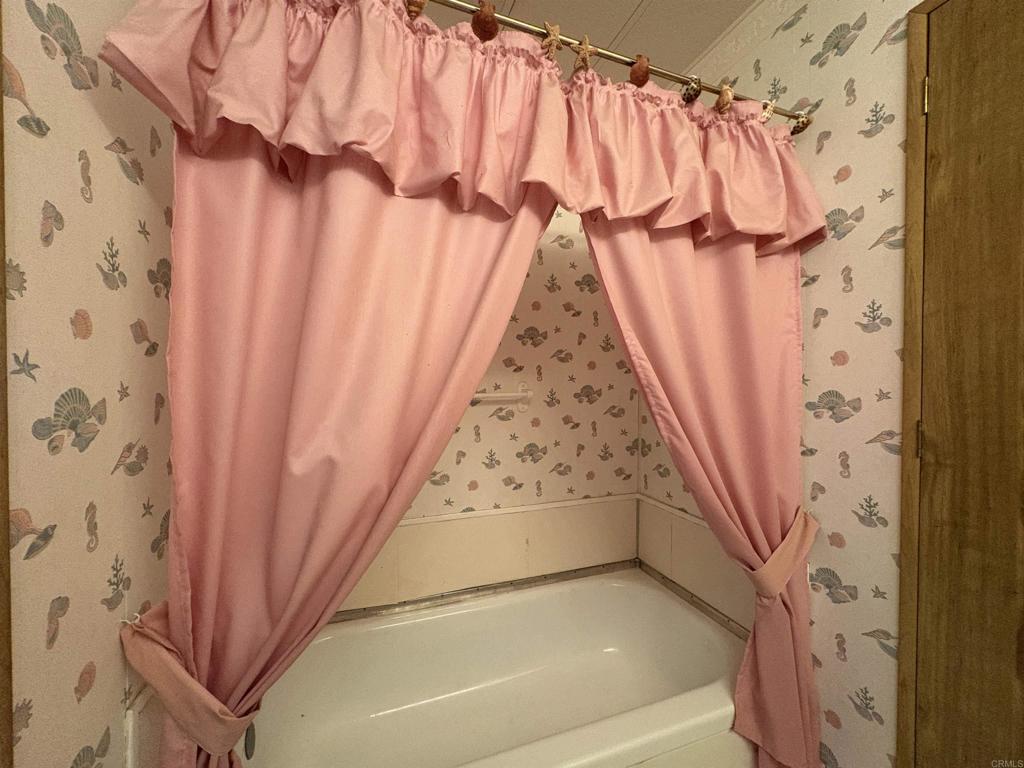 7467 Mission Gorge Road, Unit 293 Santee, CA 92071 - Photo 17 of 49 a bathroom with a shower curtain and a window