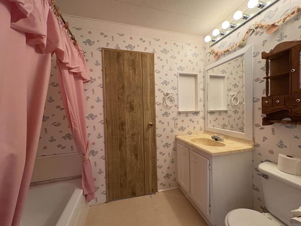 7467 Mission Gorge Road, Unit 293 Santee, CA 92071 - Photo 18 of 49 a bathroom with a sink a toilet and shower
