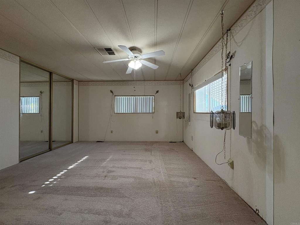 7467 Mission Gorge Road, Unit 293 Santee, CA 92071 - Photo 23 of 49 a view of a livingroom with a ceiling fan and window