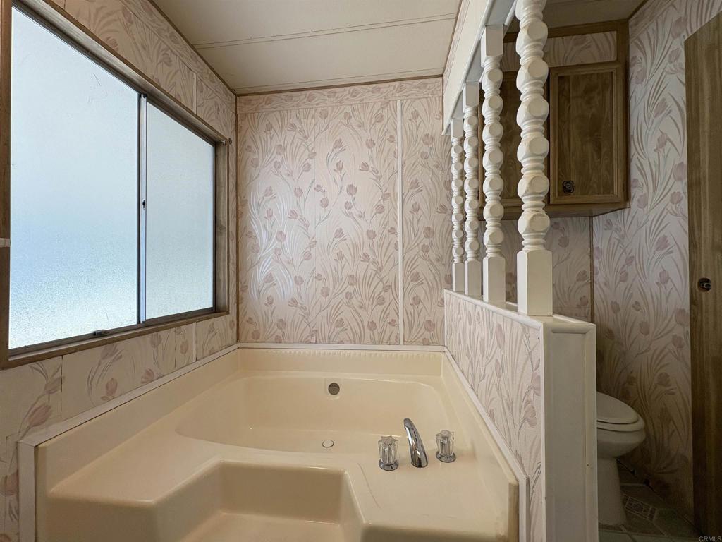 7467 Mission Gorge Road, Unit 293 Santee, CA 92071 - Photo 26 of 49 a bathroom with a bathtub and shower
