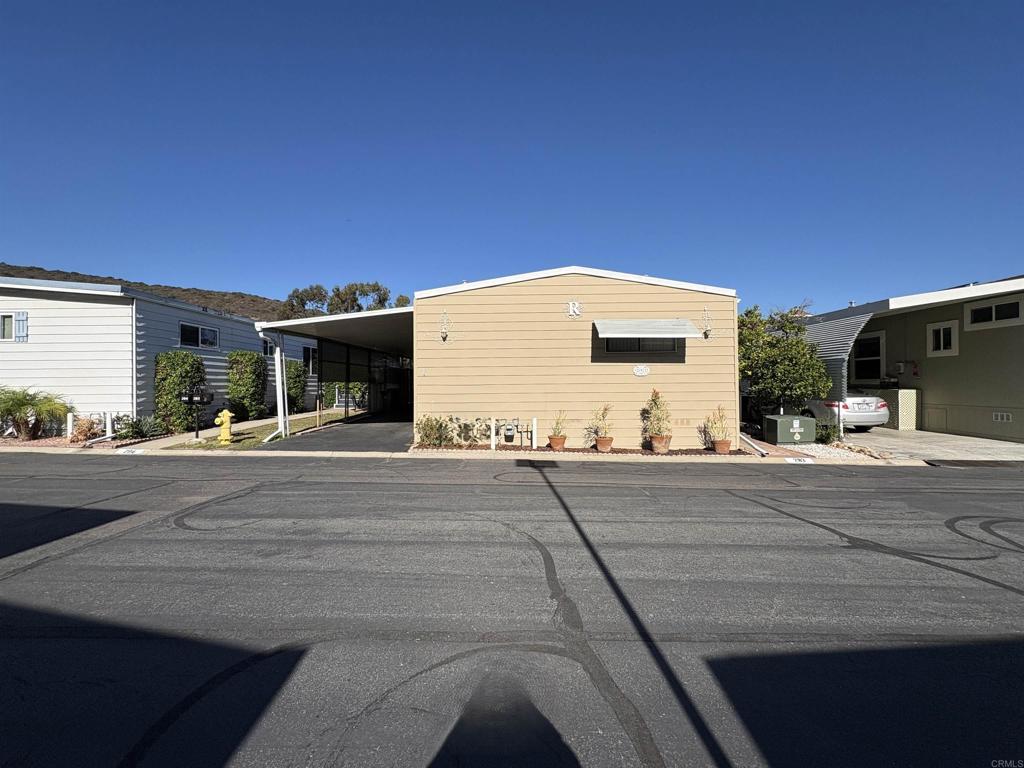 7467 Mission Gorge Road, Unit 293 Santee, CA 92071 - Photo 47 of 49 a front view of a house with a yard