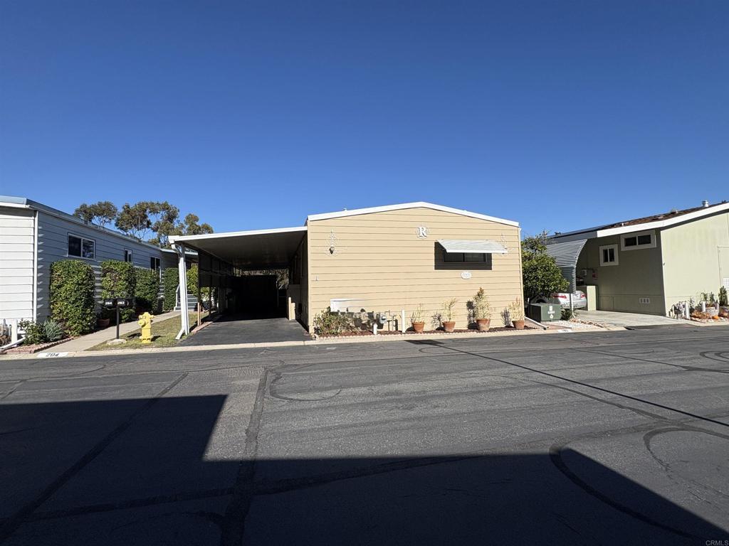 7467 Mission Gorge Road, Unit 293 Santee, CA 92071 - Photo 48 of 49 a front view of a house with a yard