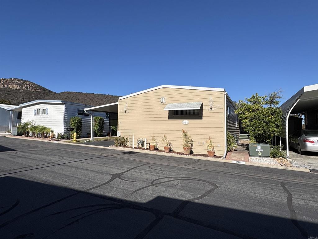 7467 Mission Gorge Road, Unit 293 Santee, CA 92071 - Photo 49 of 49 a backyard of a house with dishwasher and wooden fence