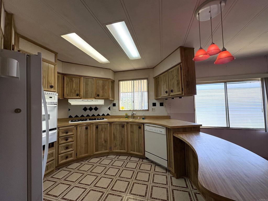 7467 Mission Gorge Road, Unit 293 Santee, CA 92071 - Photo 5 of 49 a kitchen with a sink stove and refrigerator