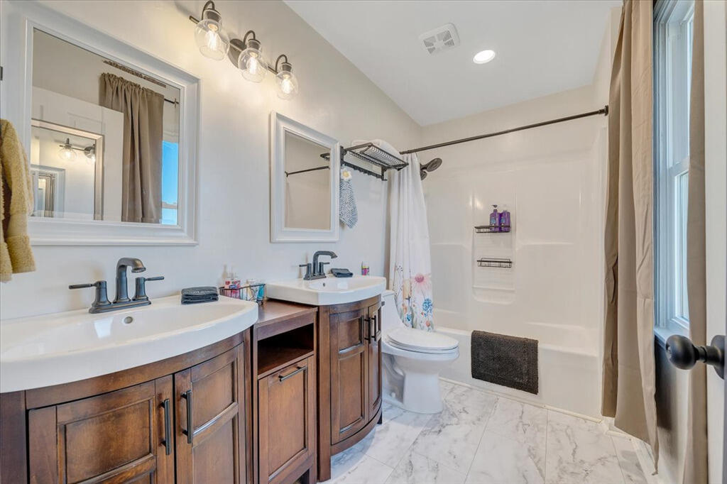 1039 Fosters Knob Road Blue Ridge, VA 24064 - Photo 19 of 45 a bathroom with a sink toilet double vanity and tub