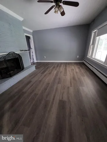 a view of a room with wooden floor and window