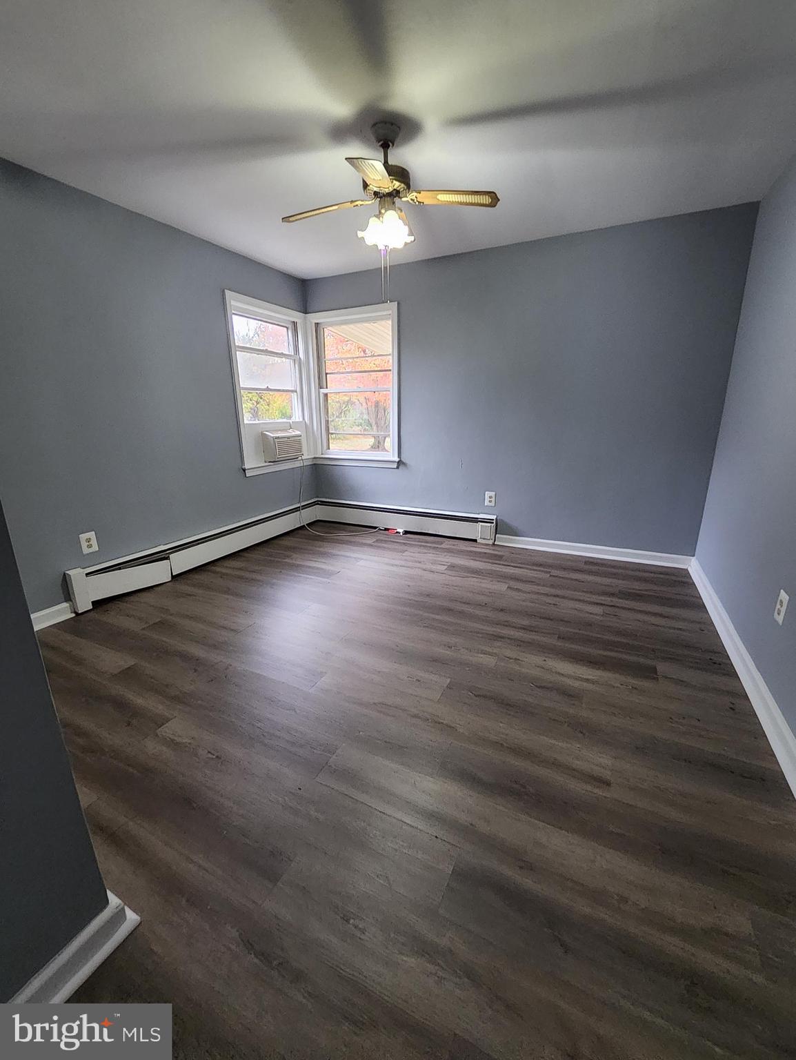 13723 Dumfries Road Manassas, VA 20112 - Photo 12 of 21 an empty room with wooden floor and windows