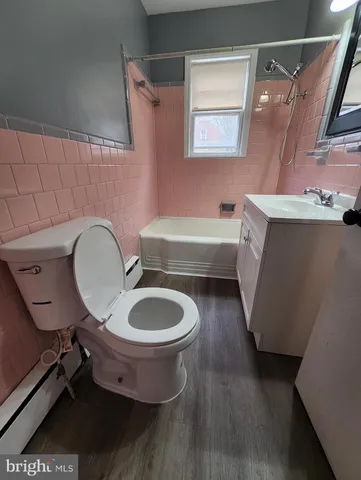 a bathroom with a sink mirror vanity and toilet
