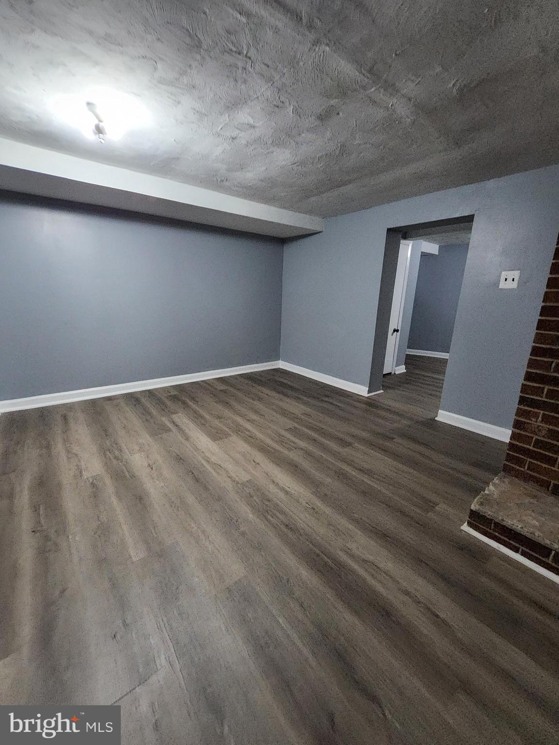 13723 Dumfries Road Manassas, VA 20112 - Photo 20 of 21 an empty room with wooden floor and windows
