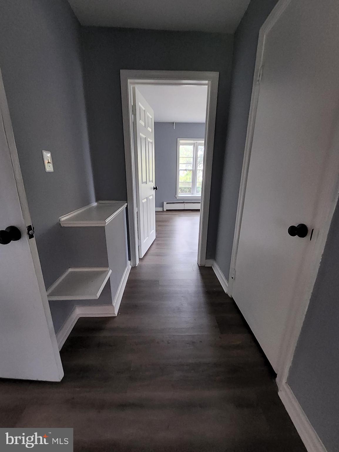13723 Dumfries Road Manassas, VA 20112 - Photo 21 of 21 a view of a hallway with wooden floor and staircase