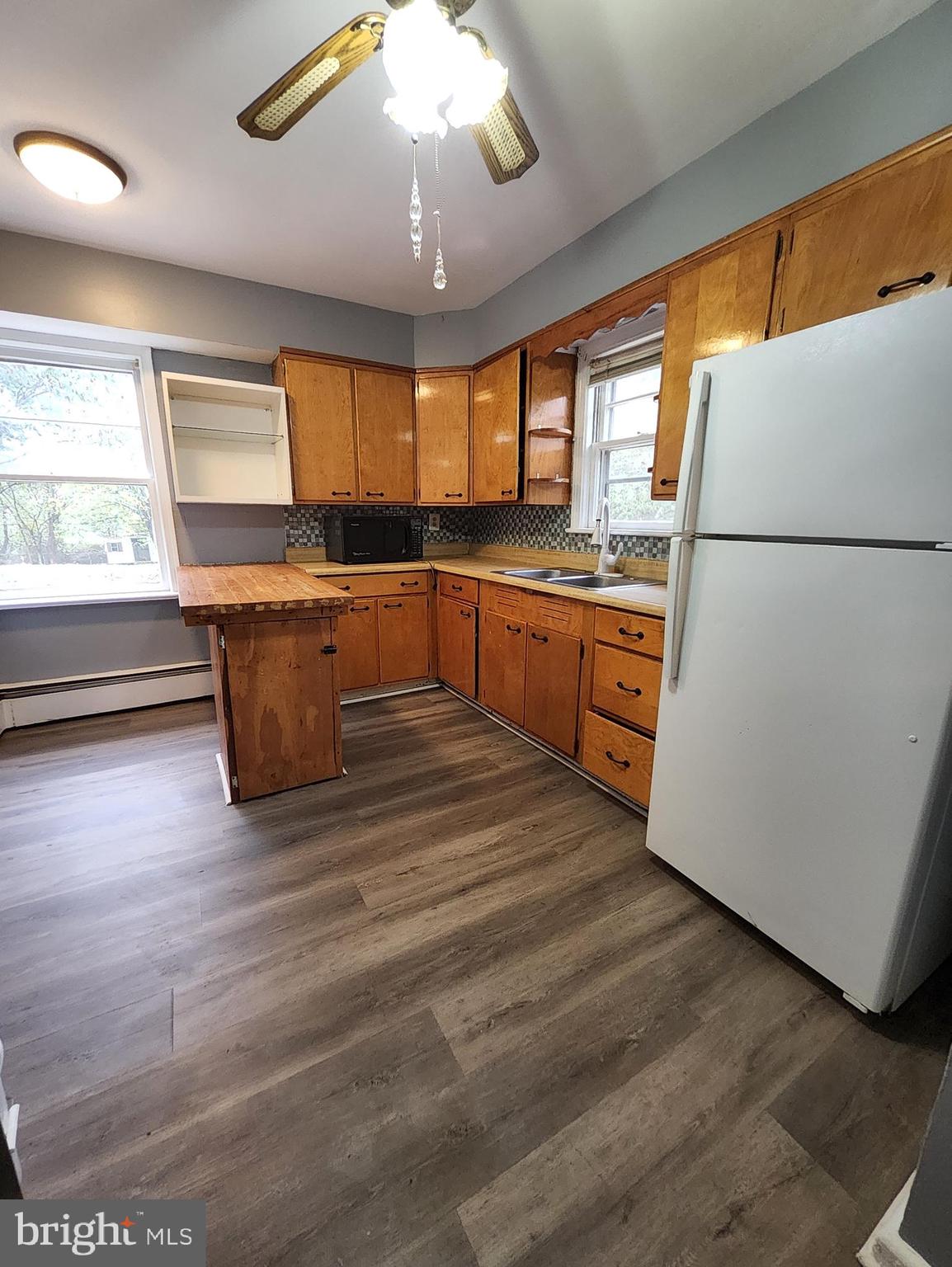 13723 Dumfries Road Manassas, VA 20112 - Photo 8 of 21 a kitchen with stainless steel appliances granite countertop a refrigerator a sink dishwasher a stove and white countertops with wooden floor