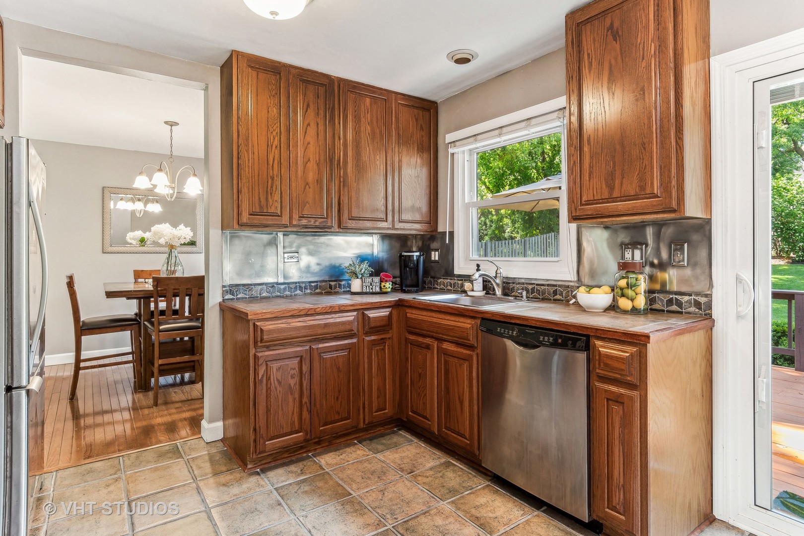 337 Cedarbrook Road Naperville, IL 60565 - Photo 8 of 37 a kitchen with stainless steel appliances granite countertop wooden cabinets a sink and a large window