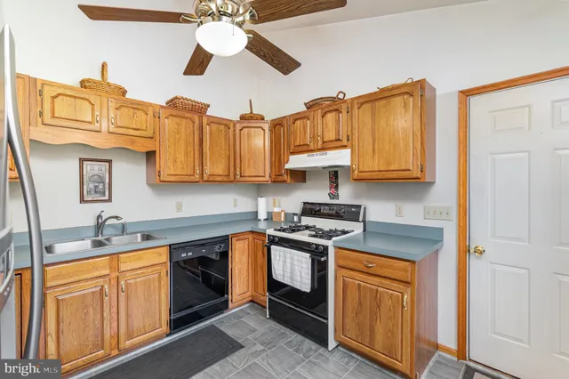 a kitchen with stainless steel appliances granite countertop a sink and cabinets