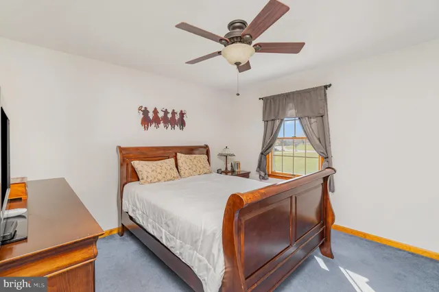 a bedroom with a bed and a dresser in it