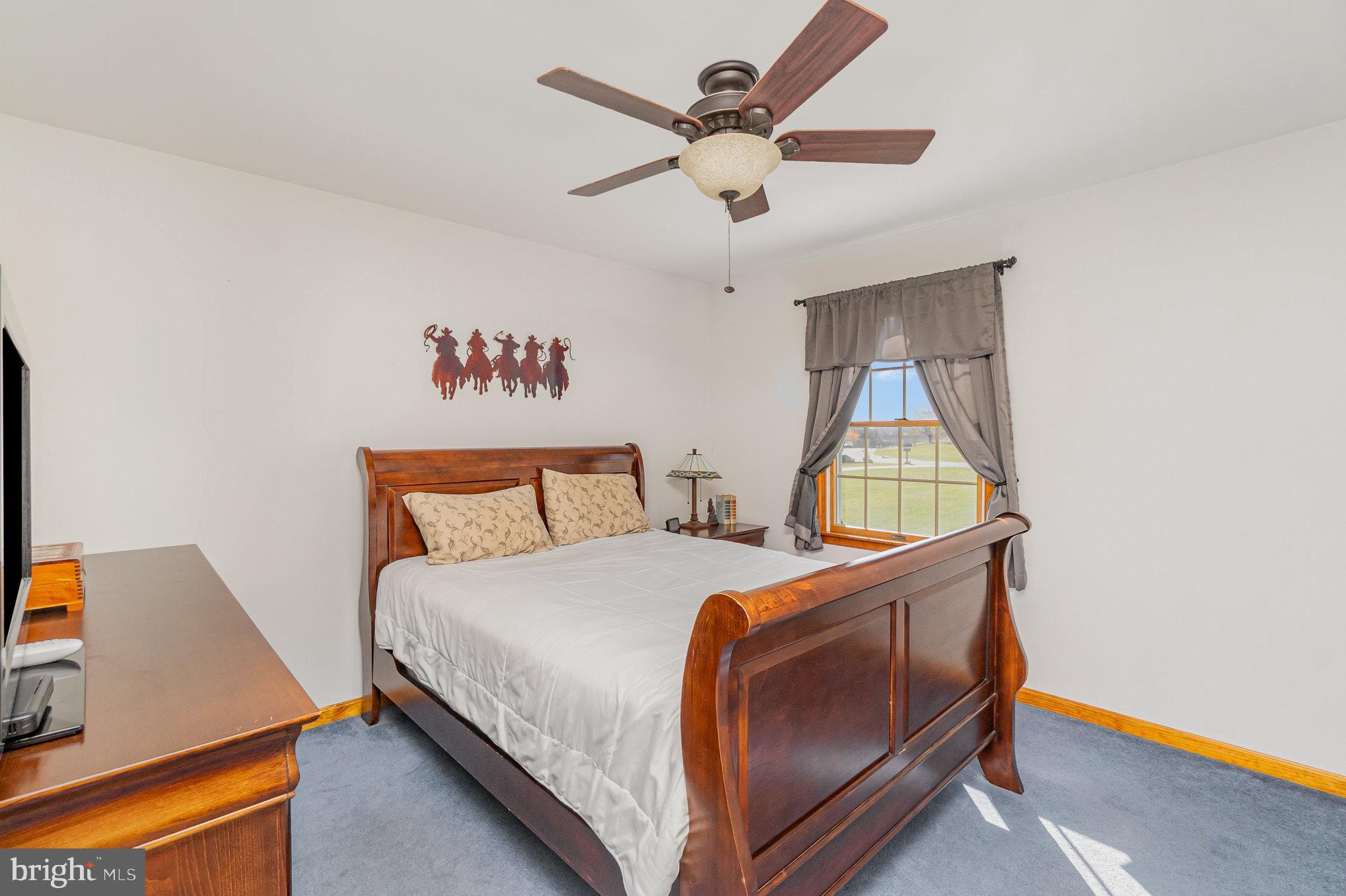 316 Hitching Post Drive Rising Sun, MD 21911 - Photo 17 of 42 a bedroom with a bed and a dresser in it
