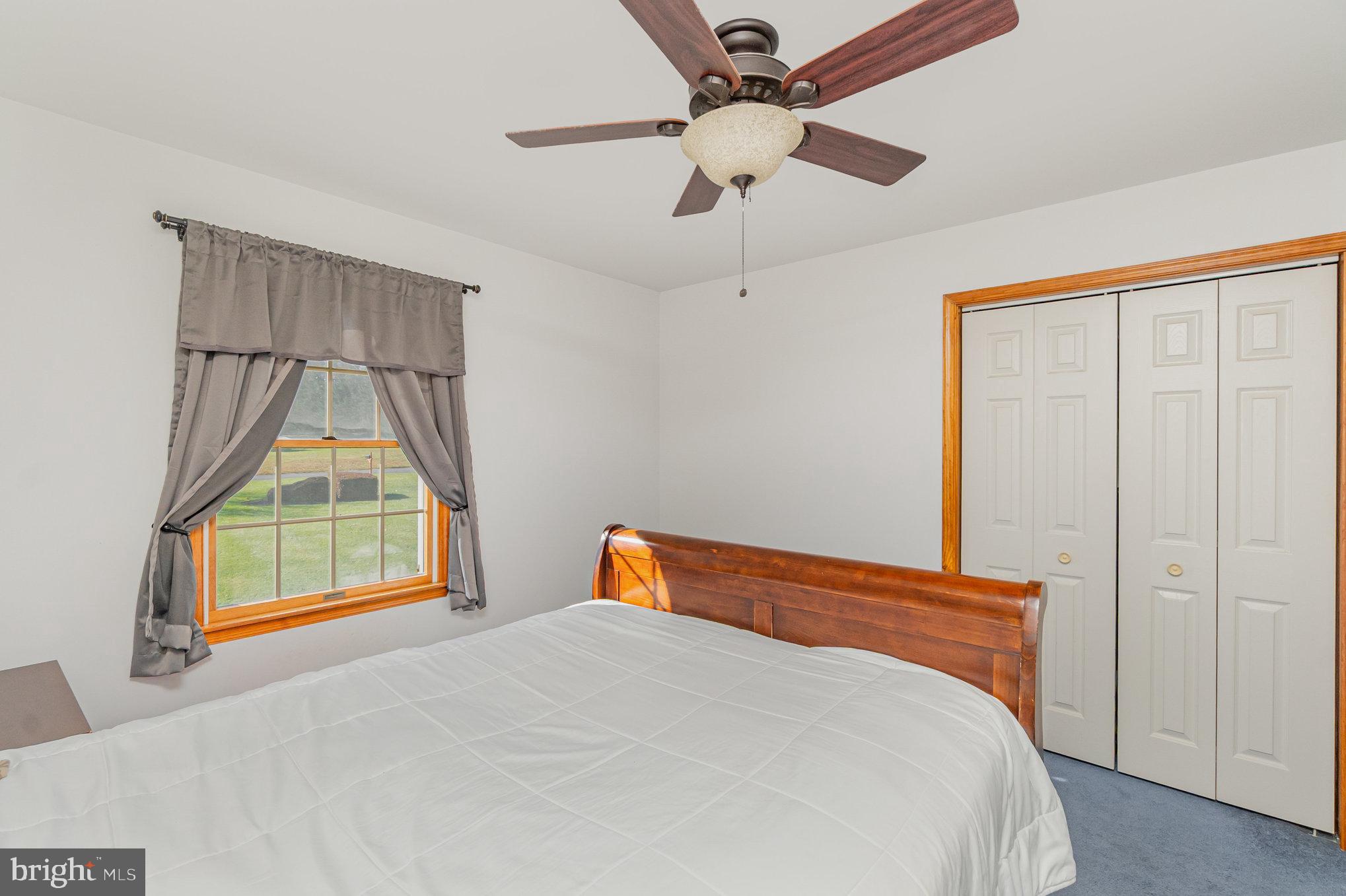 316 Hitching Post Drive Rising Sun, MD 21911 - Photo 18 of 42 a bedroom with a bed and a chandelier