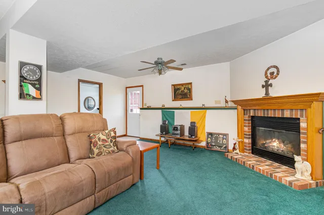a living room with furniture and a fireplace