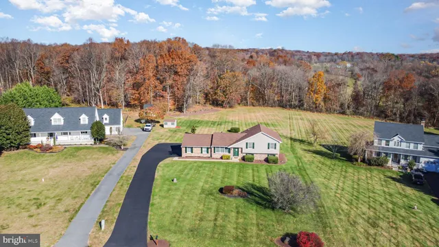 an aerial view of beach and residential houses with outdoor space