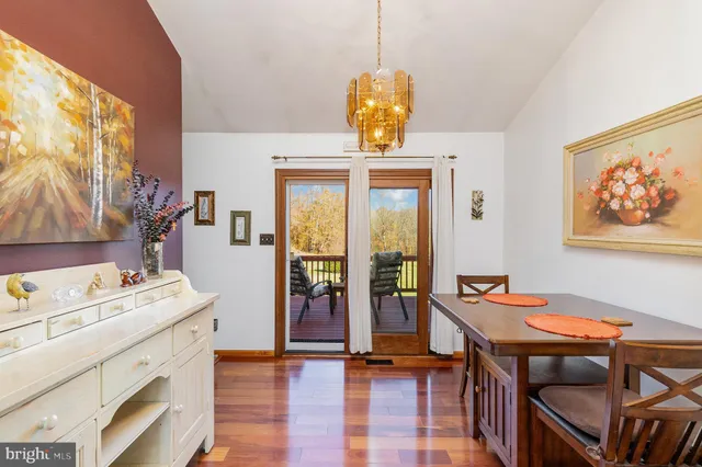 a view of a dining room with furniture and chandelier