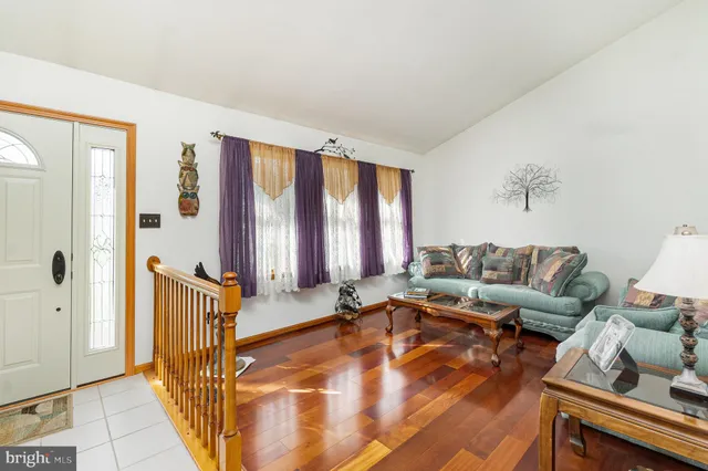 a living room with furniture and large windows