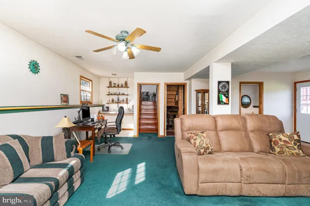 a living room with furniture and a chandelier