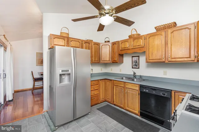a kitchen with stainless steel appliances granite countertop a refrigerator a sink and dishwasher