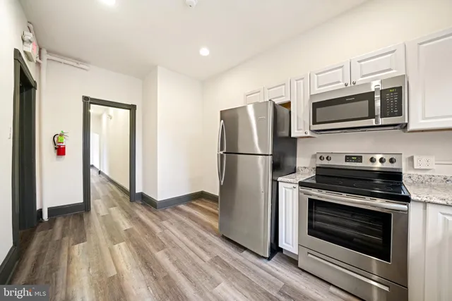 a kitchen with stainless steel appliances a refrigerator stove and microwave