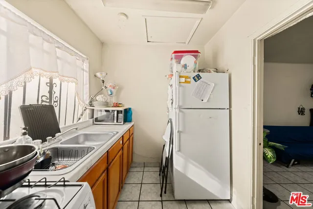 a bedroom with two bed and a night stand