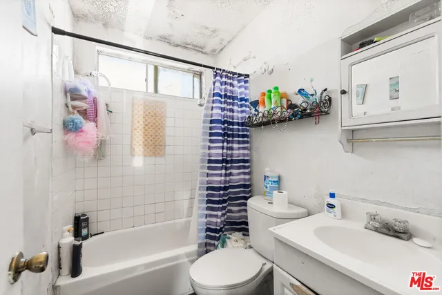 a kitchen with a sink a stove and cabinets