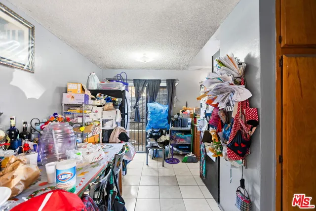 a kitchen with stainless steel appliances granite countertop a sink dishwasher and a refrigerator with wooden floor