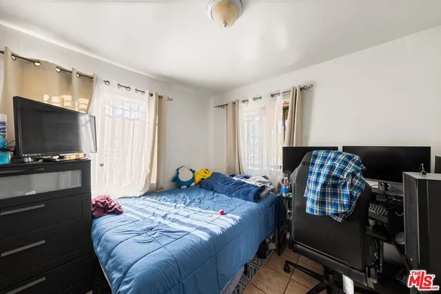 a spacious bedroom with a bed and a window