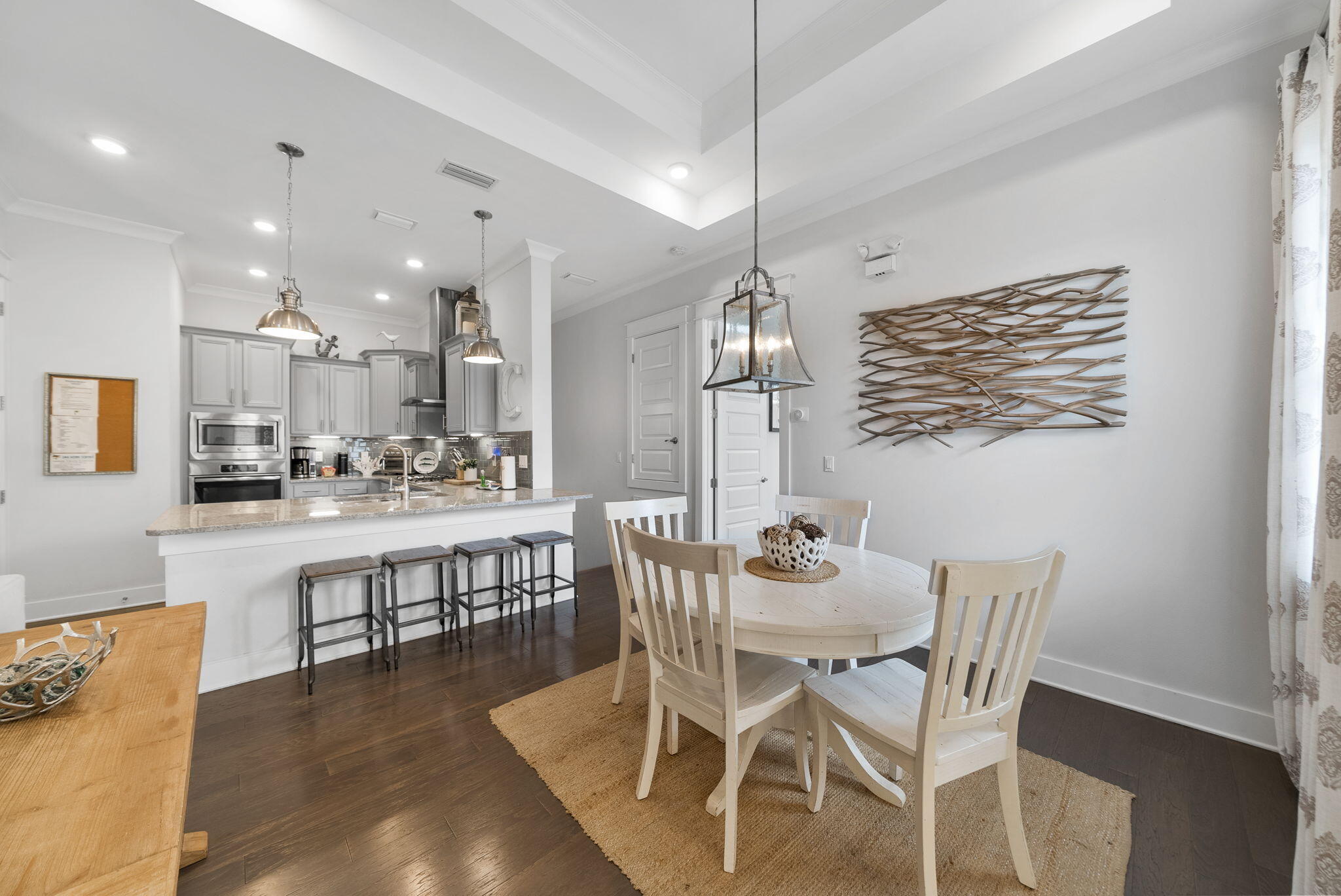 11 East E Pine, Unit C Inlet Beach, FL 32461 - Photo 12 of 40 a dining area with stainless steel appliances kitchen island granite countertop a dining table chairs and a refrigerator
