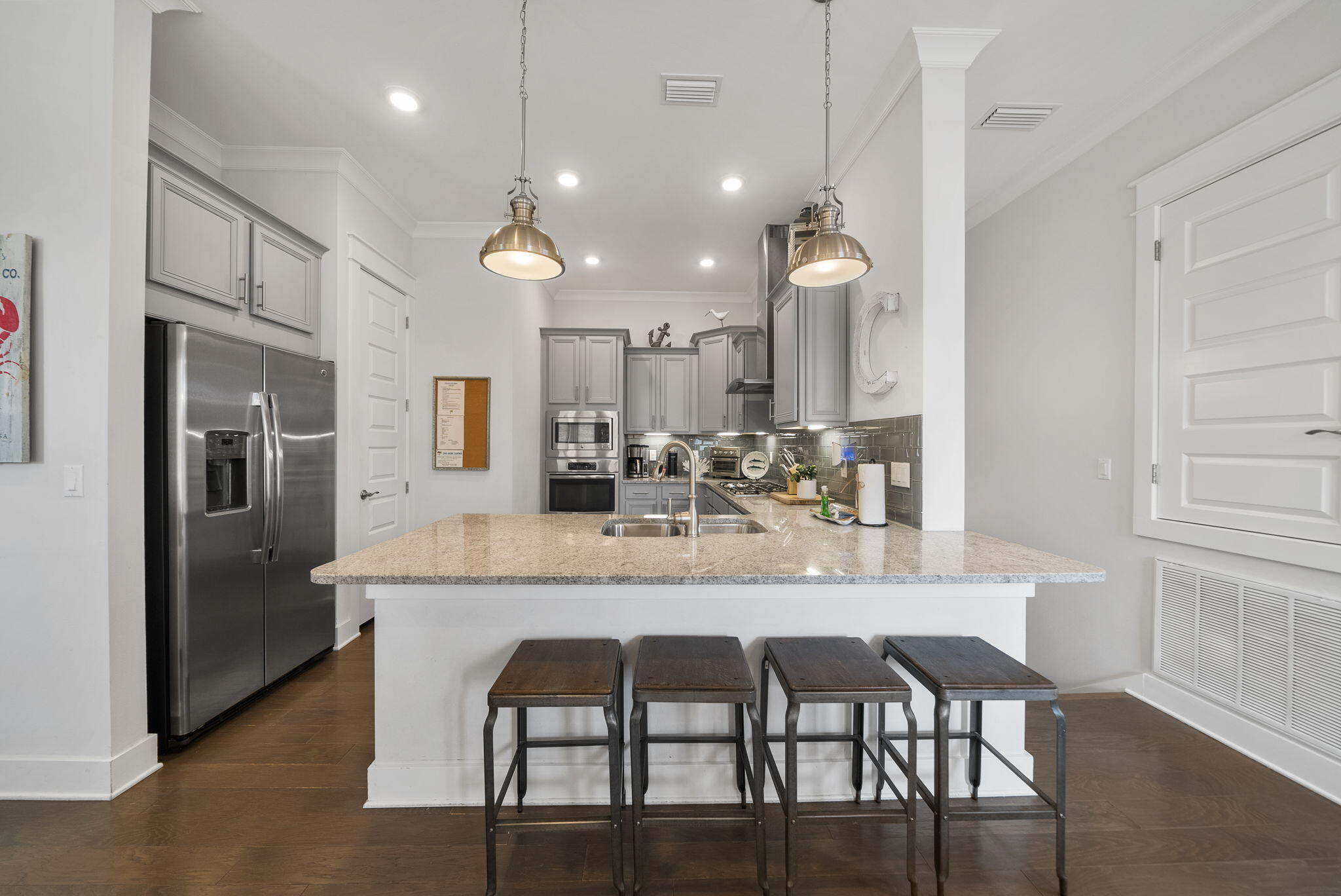 11 East E Pine, Unit C Inlet Beach, FL 32461 - Photo 13 of 40 a kitchen with granite countertop a table chairs stove and refrigerator