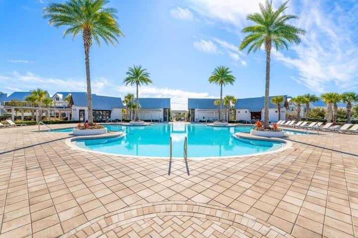 11 East E Pine, Unit C Inlet Beach, FL 32461 - Photo 31 of 40 a view of a swimming pool with a yard and palm trees