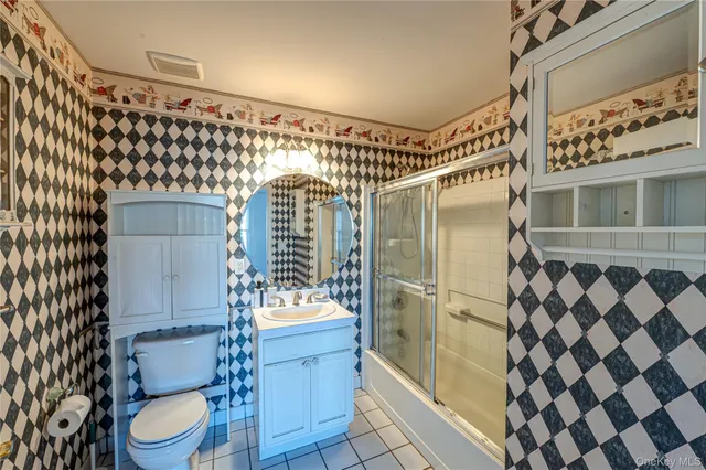 a bathroom with a toilet and shower