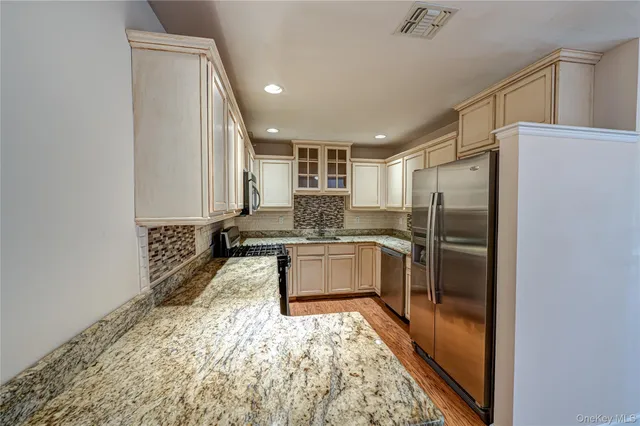 a large kitchen with a refrigerator and a sink