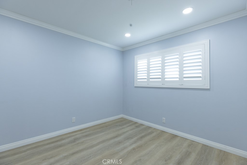 4821 Cathy Avenue Cypress, CA 90630 - Photo 13 of 21 an empty room with wooden floor and windows