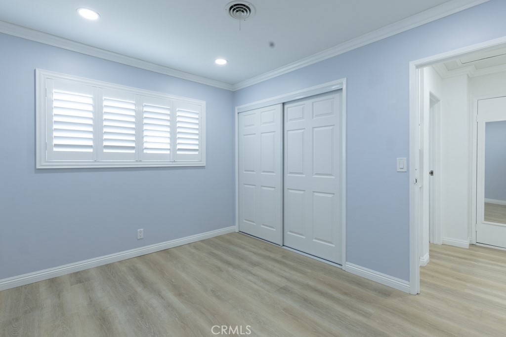 4821 Cathy Avenue Cypress, CA 90630 - Photo 14 of 21 a view of an empty room with wooden floor and a window
