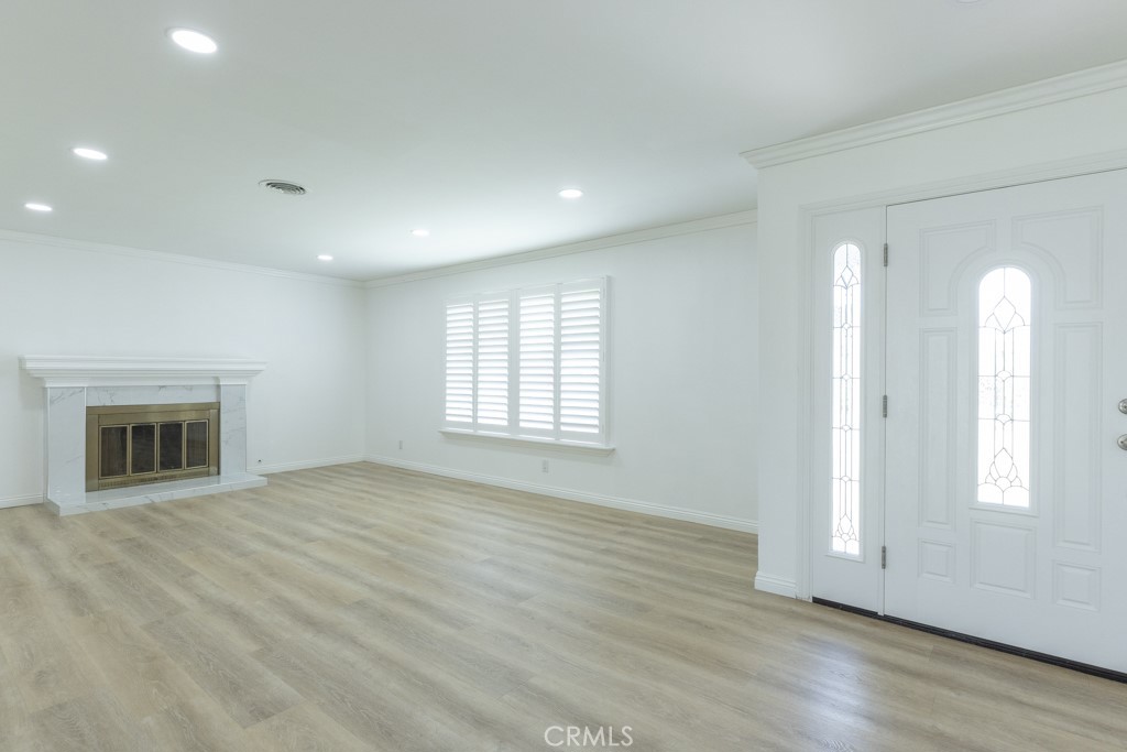 4821 Cathy Avenue Cypress, CA 90630 - Photo 2 of 21 an empty room with wooden floor and a fireplace