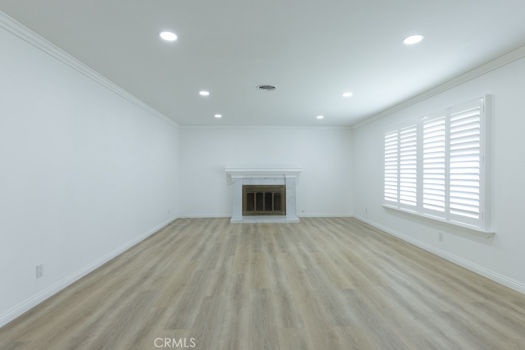 4821 Cathy Avenue Cypress, CA 90630 - Photo 3 of 21 an empty room with wooden floor and windows