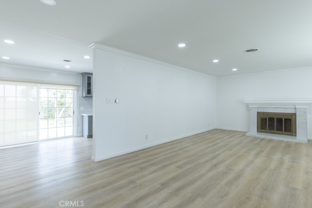 4821 Cathy Avenue Cypress, CA 90630 - Photo 4 of 21 an empty room with wooden floor and fireplace