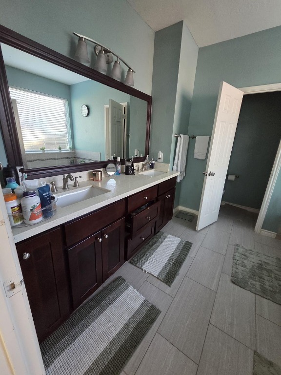 1203 Cardinal Lane Round Rock, TX 78681 - Photo 12 of 17 a bathroom with a double vanity sink and mirror