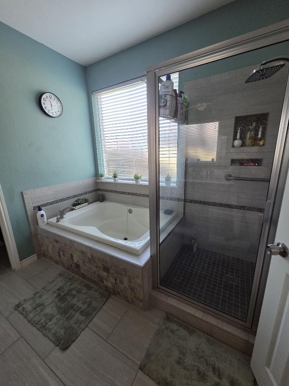 1203 Cardinal Lane Round Rock, TX 78681 - Photo 13 of 17 a bathroom with a tub and a shower
