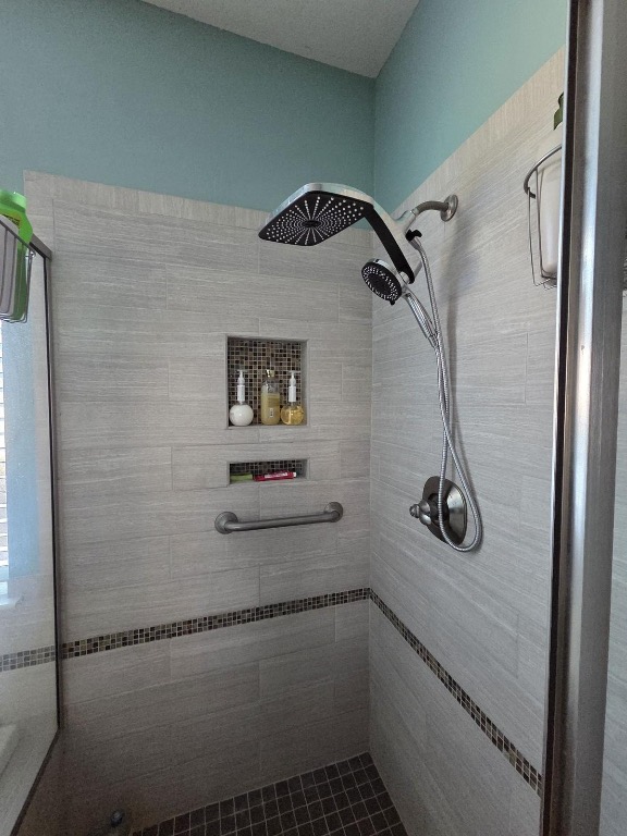 1203 Cardinal Lane Round Rock, TX 78681 - Photo 14 of 17 a bathroom with a shower and mirror