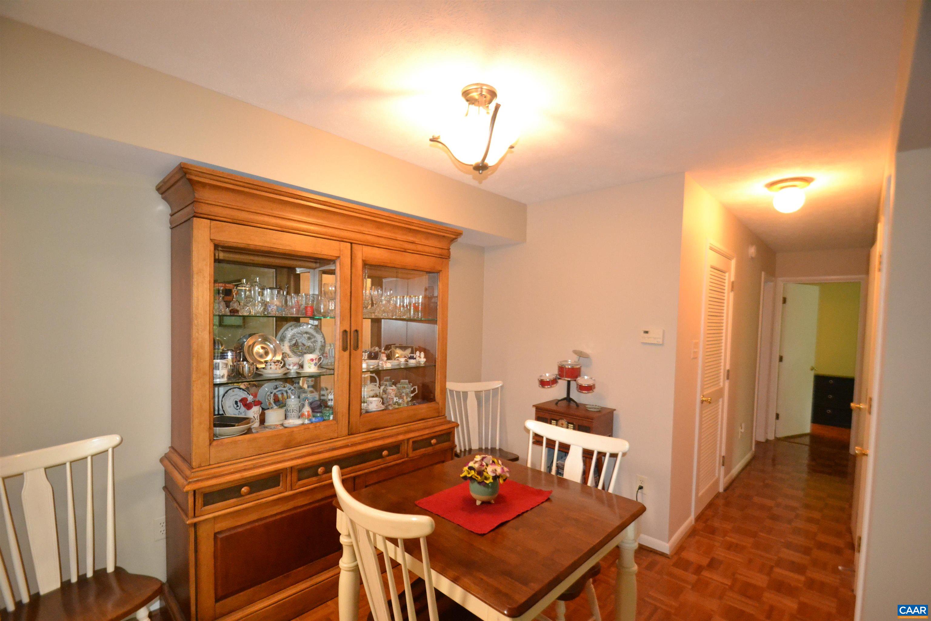 116 Turtle Creek Road, Unit 2 Charlottesville, VA 22901 - Photo 12 of 39 a living room with furniture a dining table and a bookshelf