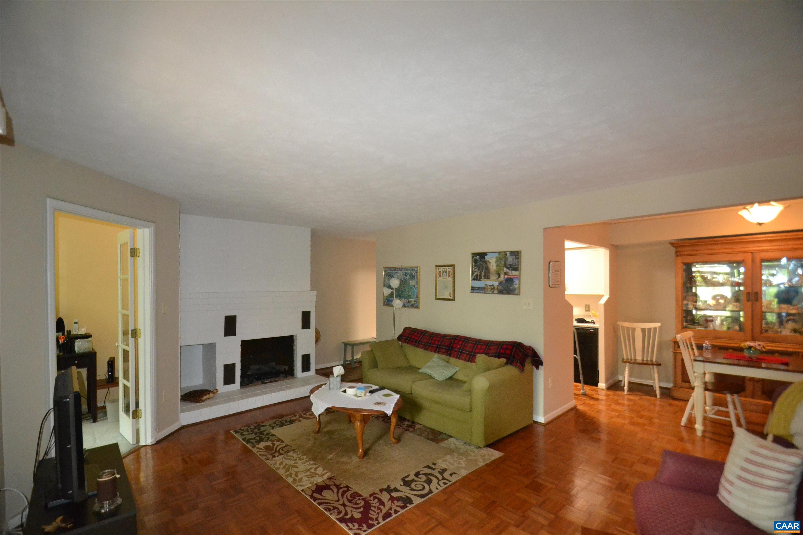 116 Turtle Creek Road, Unit 2 Charlottesville, VA 22901 - Photo 17 of 39 a living room with furniture a fireplace and a table