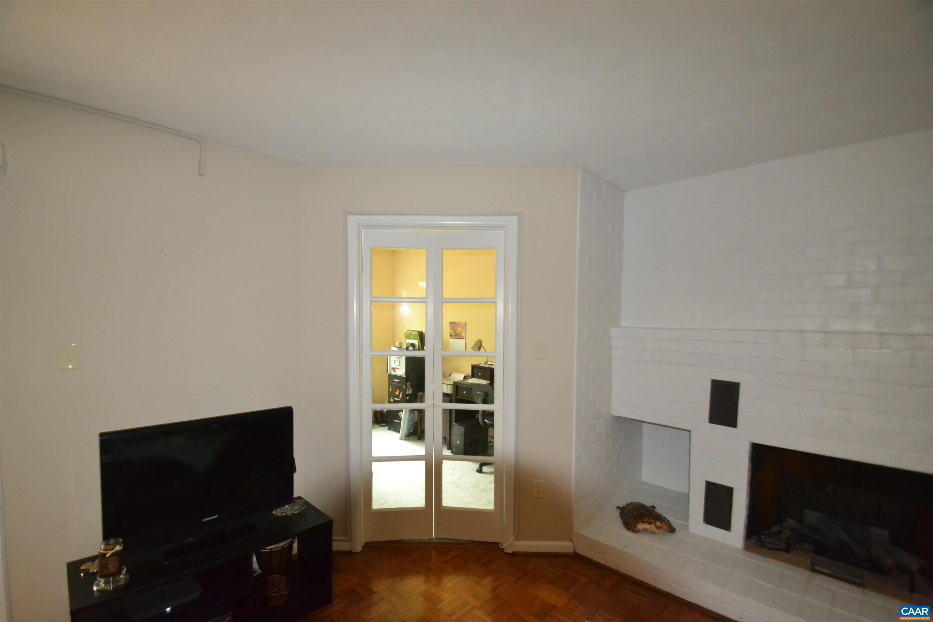 116 Turtle Creek Road, Unit 2 Charlottesville, VA 22901 - Photo 21 of 39 a living room with a flat tv and a fireplace