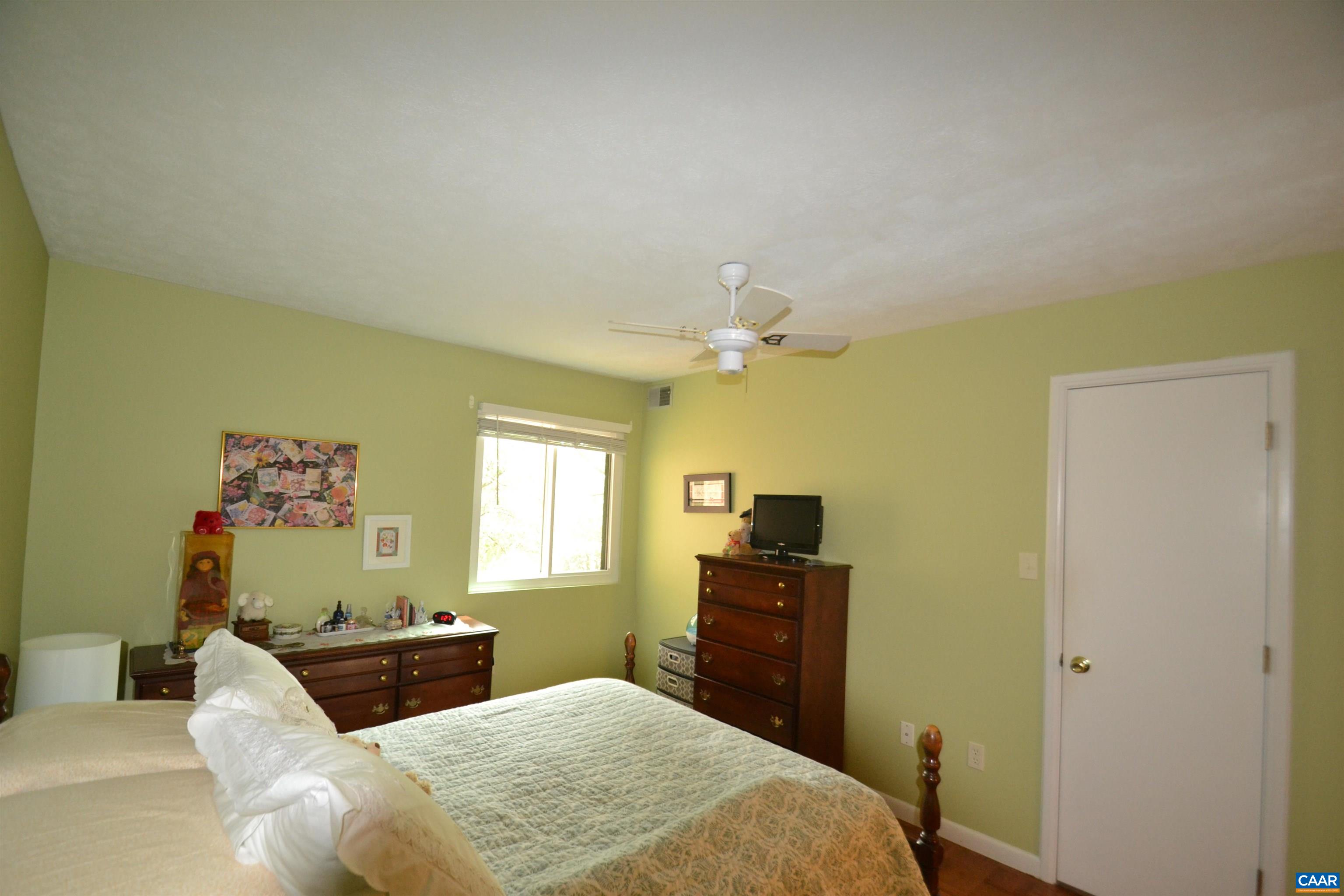 116 Turtle Creek Road, Unit 2 Charlottesville, VA 22901 - Photo 27 of 39 a bedroom with a bed and wooden floor